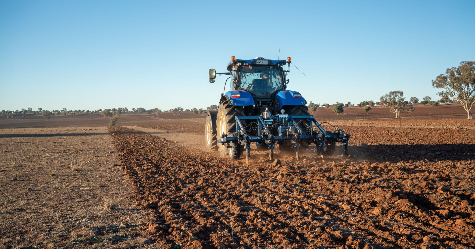 AP31 3PL mid sized plough deep ripping behind new holland tractor