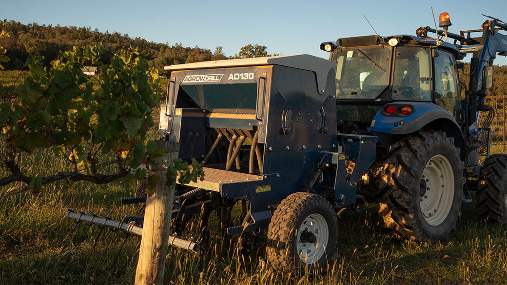 Agrowdrill vineyard seeder amongst trellis
