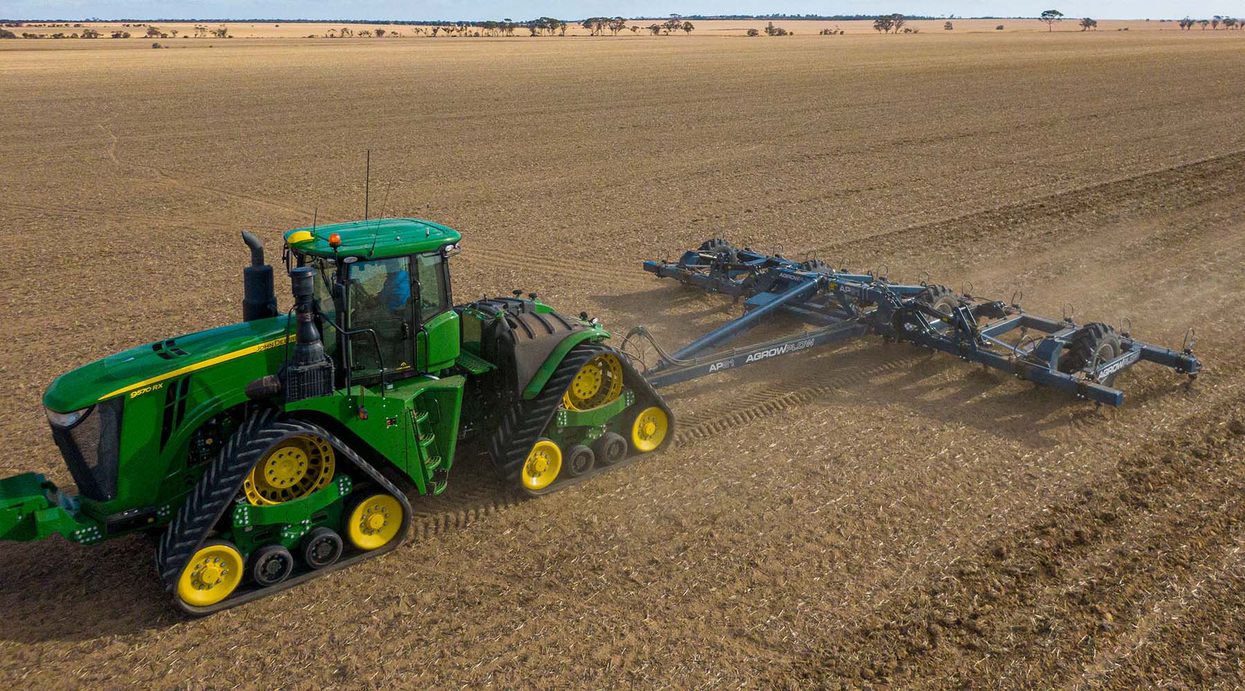 AP81 behind large John Deere tractor